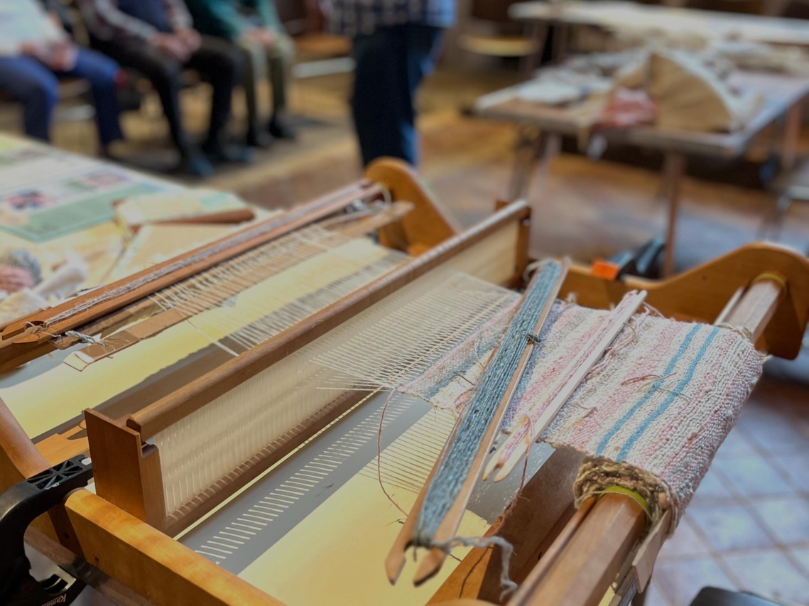 Multicoloured textile on a weaving loom.