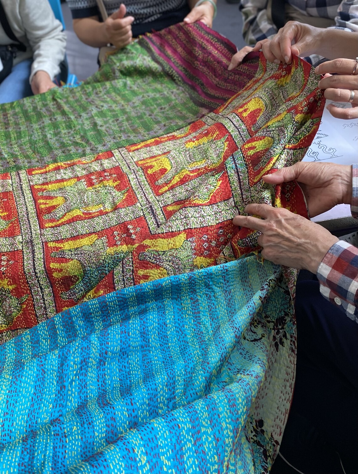 women holding a Kantha fabric 